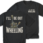 A black t-shirt shown from both the front and back. The front features the phrase 'I'LL BE OUT WHEELING' printed in a distressed off-white font on the left chest.