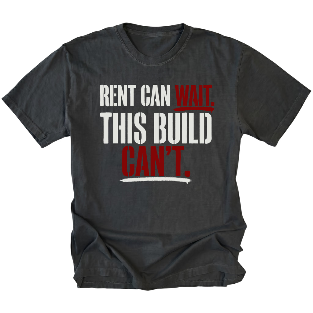 Black T-Shirt featuring Rent Can Wait This Build Can't text design in bold typography on front view by Trail Snark.