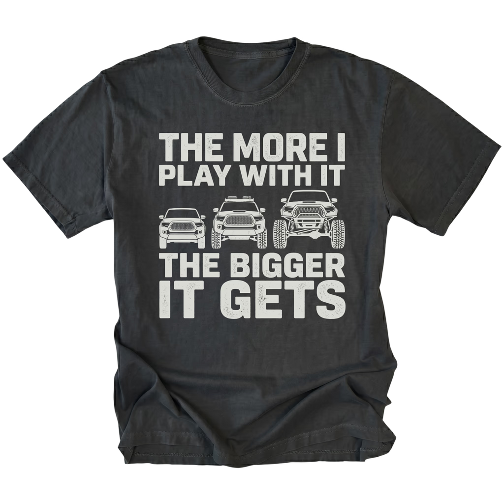 Black T-Shirt featuring The More I Play With It The Bigger It Gets design with three progressively lifted trucks shown on the front view by Trail Snark.