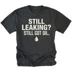 Black T-Shirt featuring the Still Leaking? Still Got Oil. design with an oil drop graphic on the front view by Trail Snark.