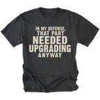 Black t-shirt featuring the Needed Upgrading design on the front by Trail Snark.