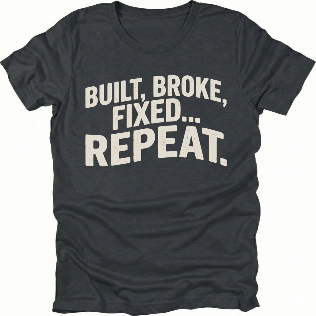 Black t-shirt featuring built broke fixed repeat bold text graphic shown from the front by Trail Snark.