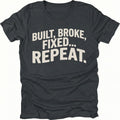 Black t-shirt featuring built broke fixed repeat bold text graphic shown from the front by Trail Snark.