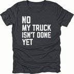 Black T-Shirt with distressed white text reading "No My Truck Isn't Done Yet" front view by Trail Snark.