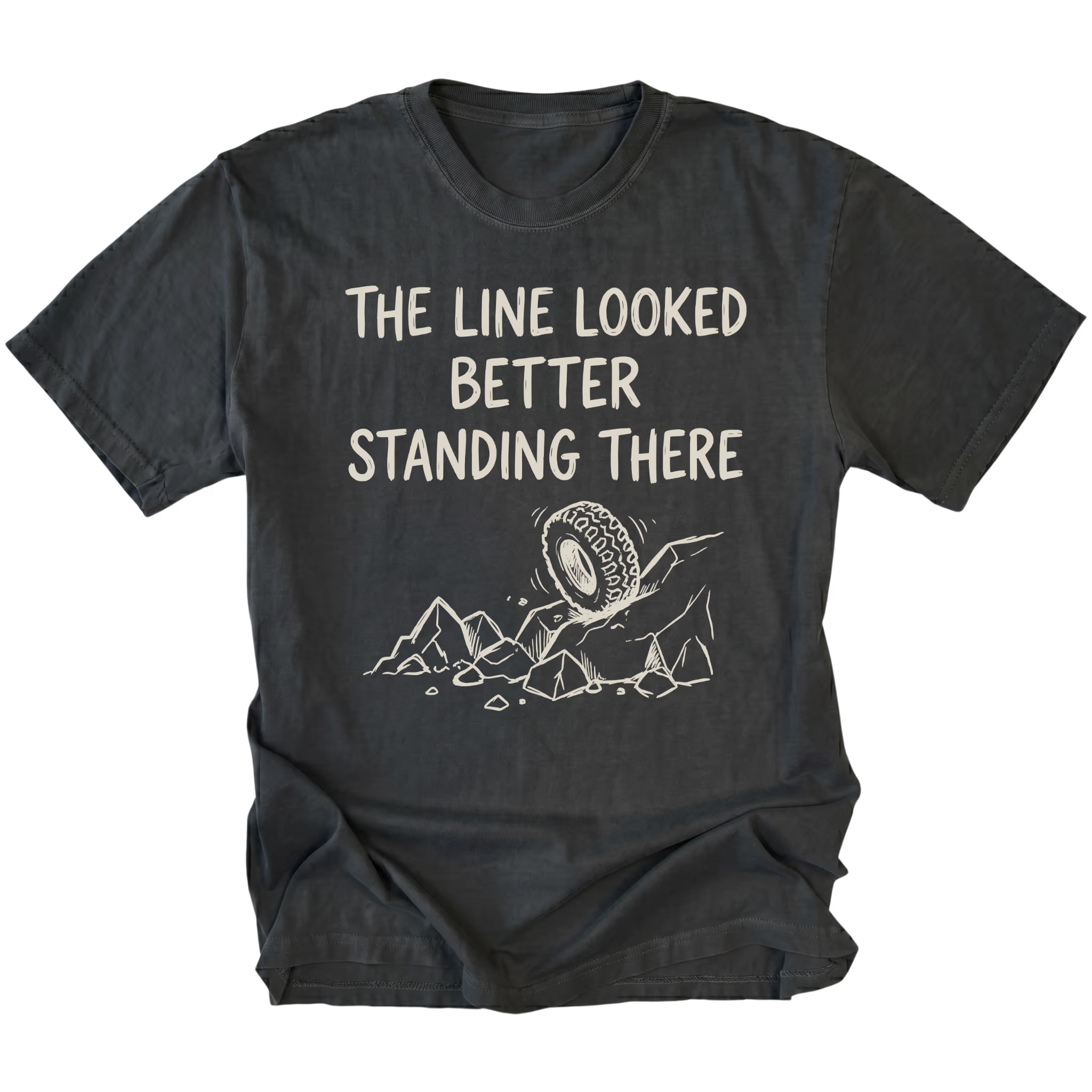 Black T-Shirt with hand-drawn tire and rocks graphic and text reading “The Line Looked Better Standing There” shown on front view by Trail Snark.