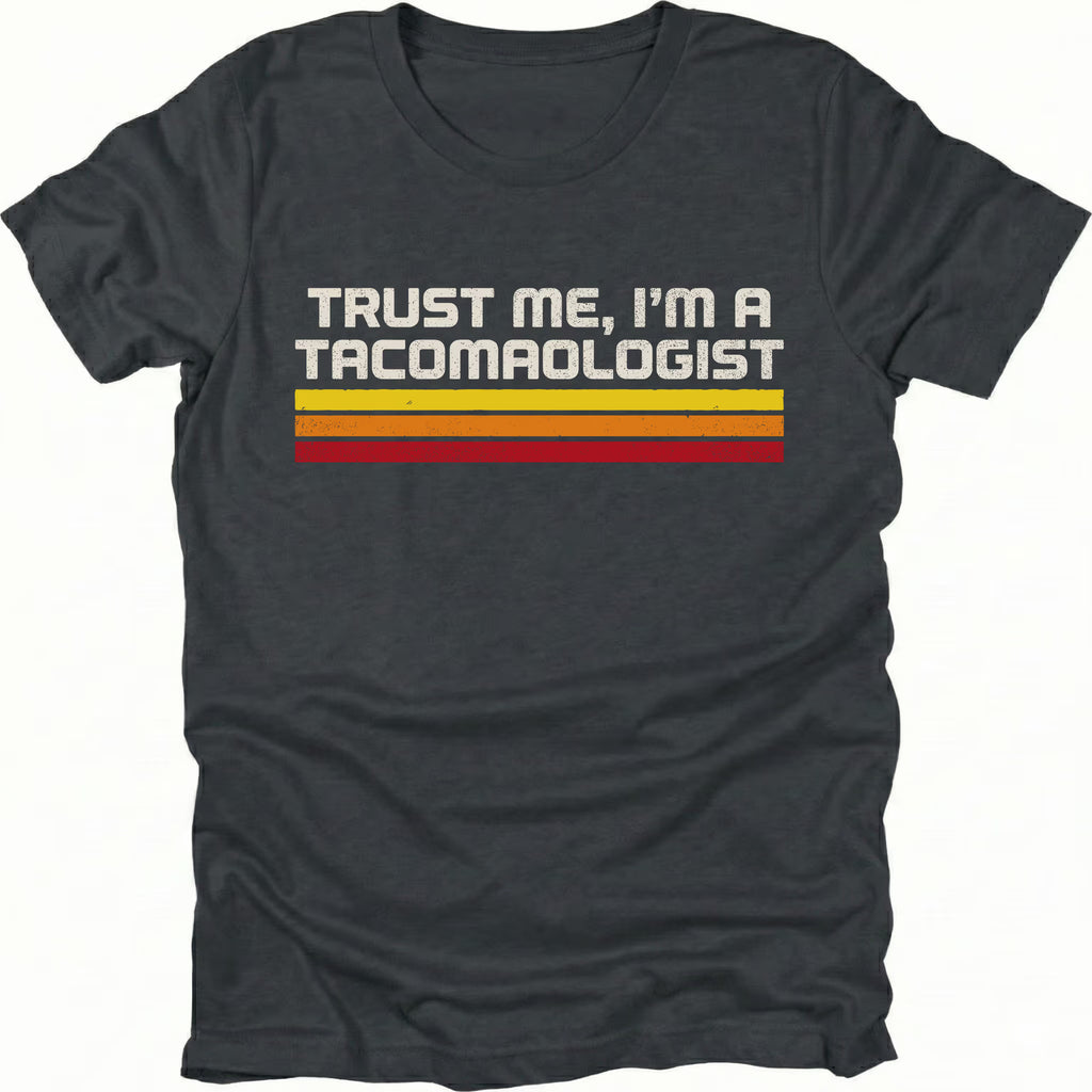 Black t-shirt with retro stripes and the phrase “Trust Me, I’m a Tacomaologist” printed on the front by Trail Snark.