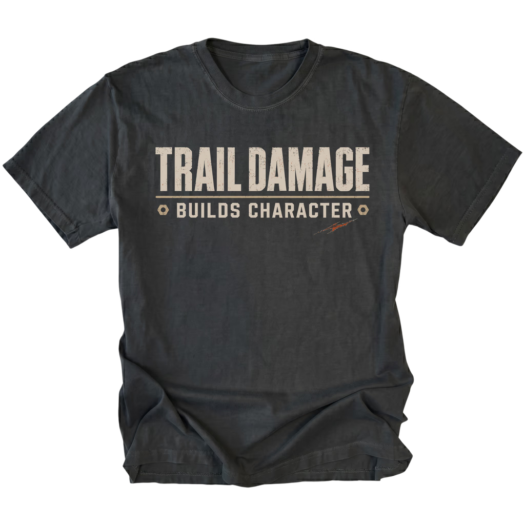 Black T-shirt featuring the Trail Damage Builds Character design on the front by Trail Snark.