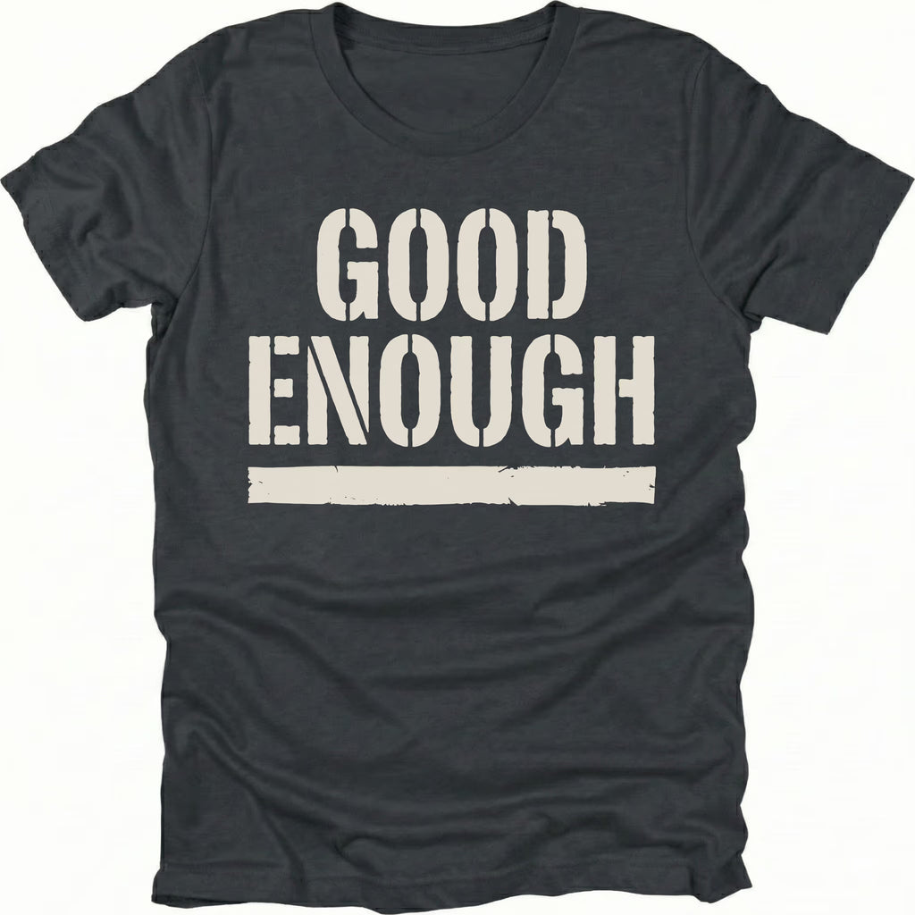 Black t-shirt featuring bold distressed text reading Good Enough with an underline displayed on the front.