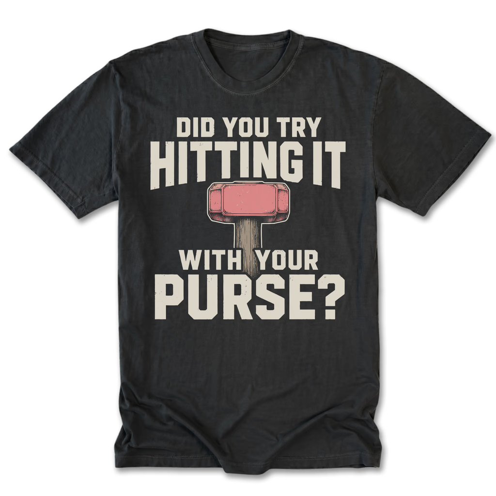 A black t-shirt with a humorous graphic print. The design features the text 'DID YOU TRY HITTING IT WITH YOUR PURSE?' in a distressed off-white font, with a pink and gray purse-shaped hammer illustration in the center.