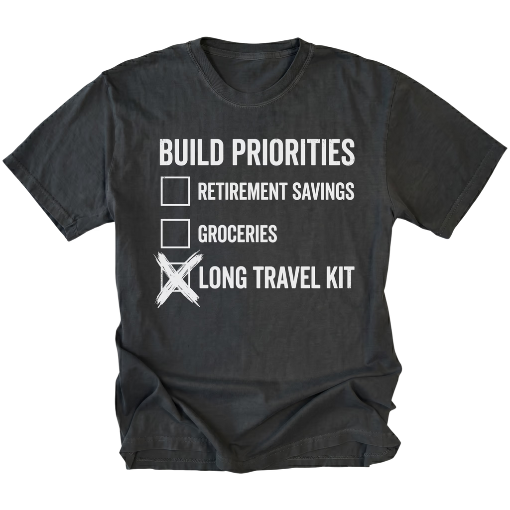 Black T-Shirt featuring Build Priorities checklist highlighting long travel kit on front view by Trail Snark.