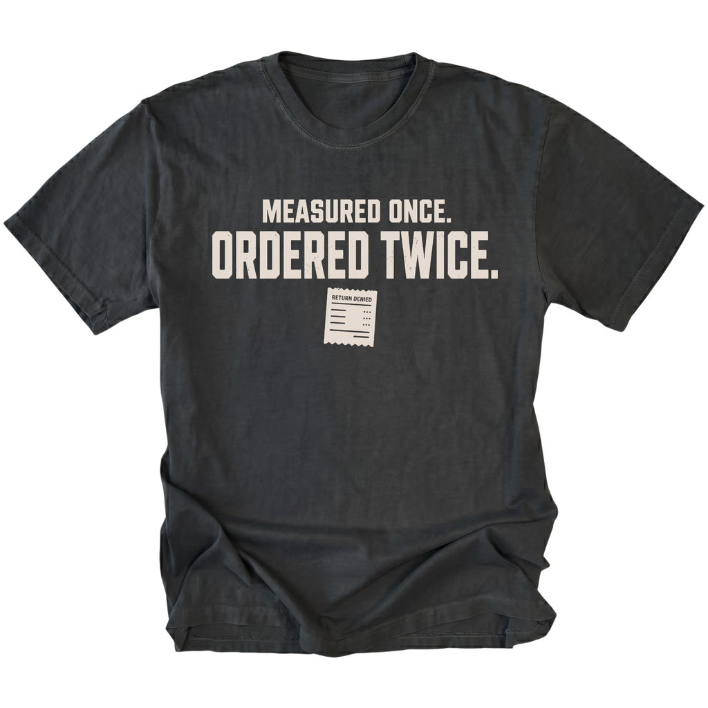 Black T-shirt with a Measured Once Ordered Twice garage humor design shown from the front by Trail Snark.