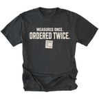 Black T-shirt with a Measured Once Ordered Twice garage humor design shown from the front by Trail Snark.