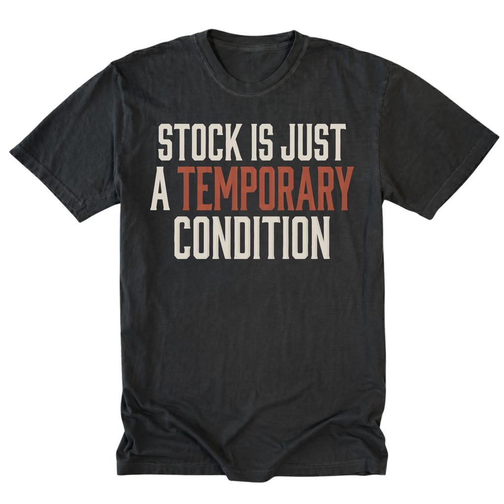 A black graphic t-shirt with the text 'STOCK IS JUST A TEMPORARY CONDITION' printed on the chest. The words 'A TEMPORARY' are highlighted in a muted orange-red color, while the other text is off-white.