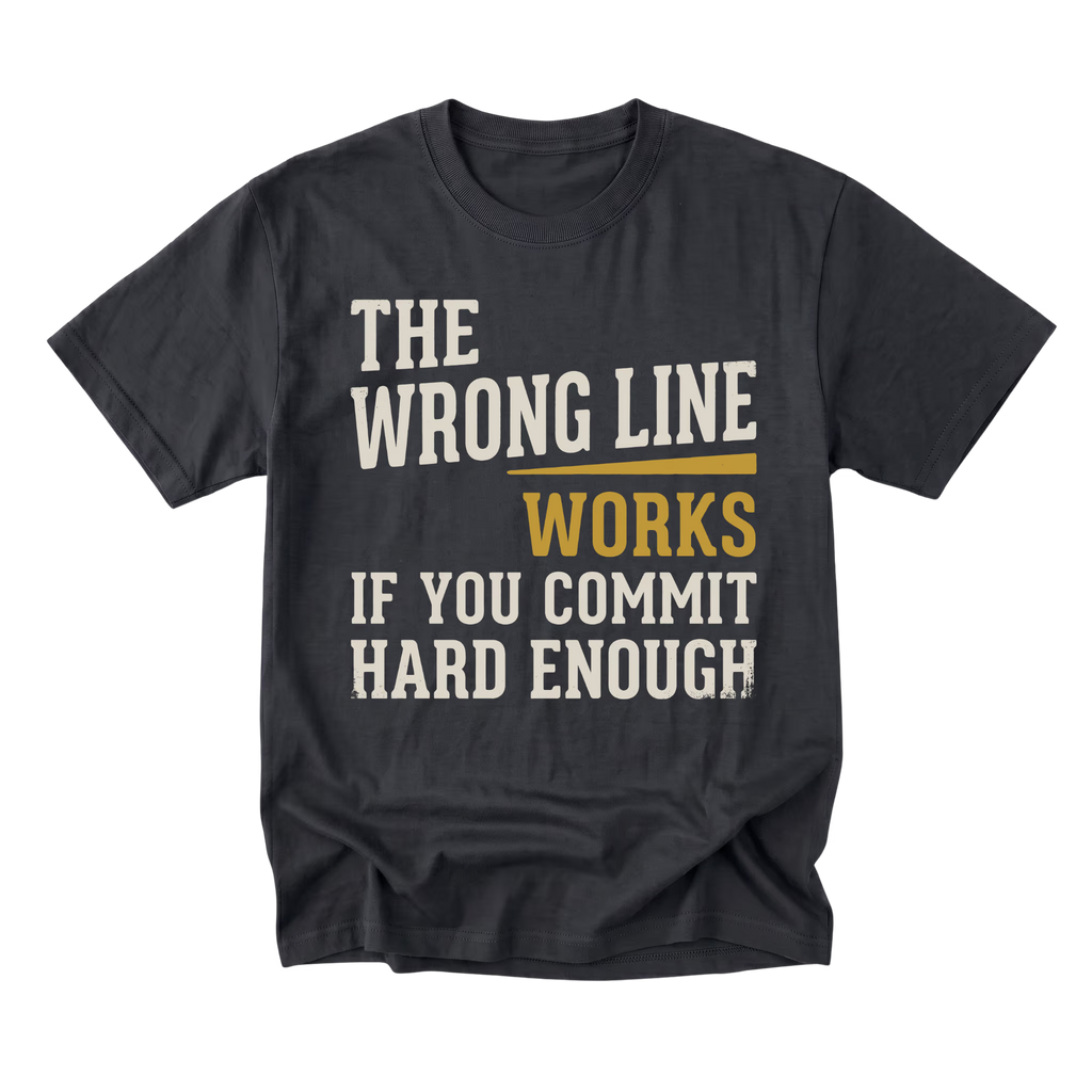 A black graphic t-shirt with a humorous quote printed on the front. The text reads 'THE WRONG LINE WORKS IF YOU COMMIT HARD ENOUGH' in distressed cream and mustard yellow lettering, displayed on a clean white background.