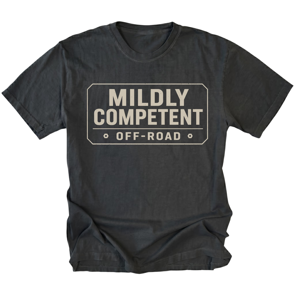 Black T-shirt with a Mildly Competent Off-Road design shown from the front by Trail Snark.