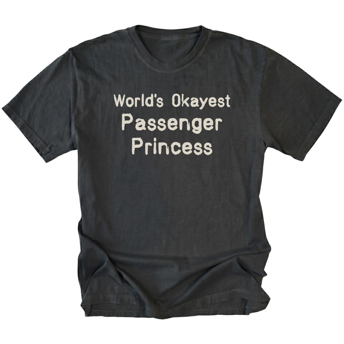 Black crewneck T-shirt shown from the front, with "World's Okayest Passenger Princess" in three lines of rough-edged cream lettering across the chest.