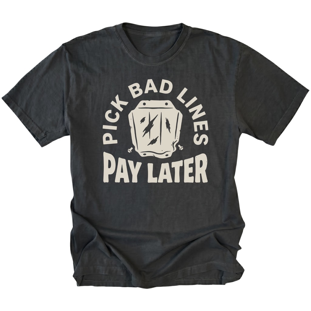 A black t-shirt with a distressed cream graphic that reads 'PICK BAD LINES PAY LATER' surrounding an illustration of a cracked mug, shown on a solid white background.