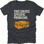 Black t-shirt with text reading “This Solves Specific Problems” above an illustrated orange hard gear case, shown in front view.