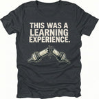 Black t-shirt with text reading “This Was a Learning Experience” above an illustration of a broken axle or CV joint, shown on the front.