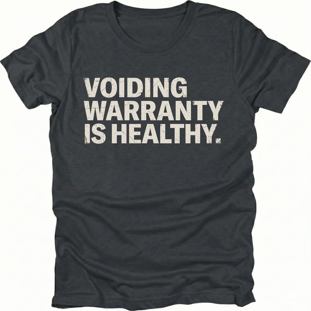 Black t-shirt with bold text reading “Voiding Warranty Is Healthy” printed on the front.