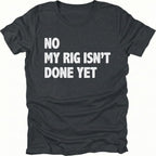 Black t-shirt with bold white text reading No My Rig Isn’t Done Yet, front view by Trail Snark.