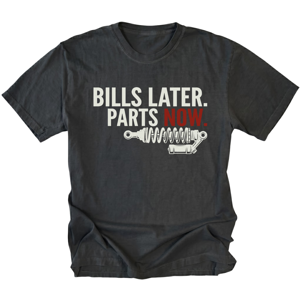 Black t-shirt featuring Bills Later Parts Now design with suspension coilover graphic on front view by Trail Snark.