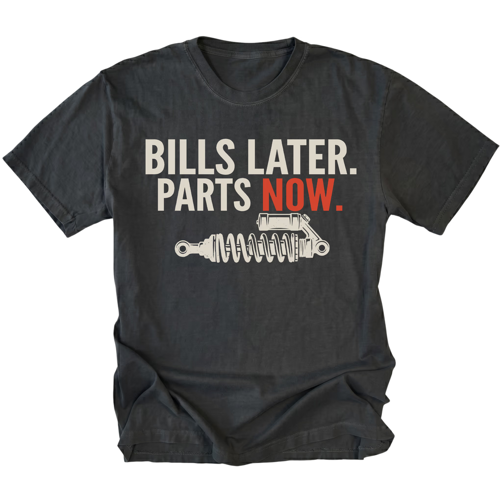 Black t-shirt featuring Bills Later Parts Now design with suspension coilover graphic on front view by Trail Snark.