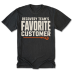 A black t-shirt with a graphic print that reads 'RECOVERY TEAM'S FAVORITE CUSTOMER' in off-white block letters, with an orange rope and hook illustration underneath, displayed on a clean white background.