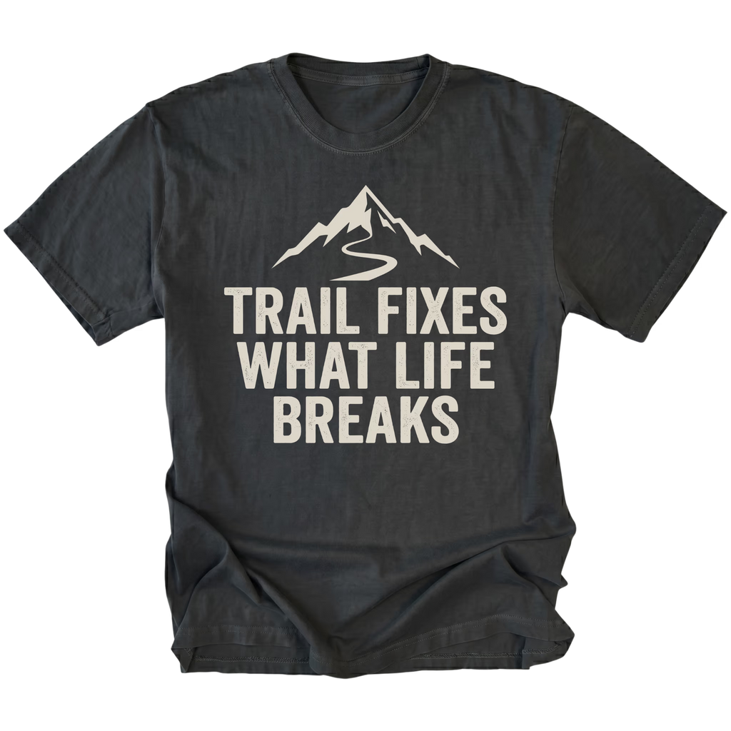 Black t-shirt with the phrase “Trail Fixes What Life Breaks” beneath a mountain and winding trail graphic printed on the front.