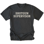 A black t-shirt with the words 'SHOTGUN SUPERVISOR' printed in a distressed off-white font across the chest, displayed flat against a solid white background.