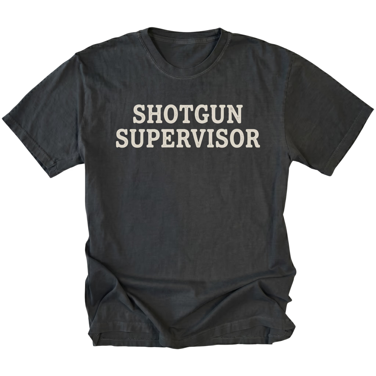 A black t-shirt with the words 'SHOTGUN SUPERVISOR' printed in a distressed off-white font across the chest, displayed flat against a solid white background.