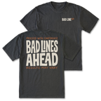 Two black graphic t-shirts shown on a white background, with the front and back views overlapping. The front features a small 'BAD LINE ART' logo on the left chest, and the back features a large graphic print reading 'PROCEED WITH CONFIDENCE BAD LINES AHEAD RESULTS MAY VARY' in cream and orange lettering.
