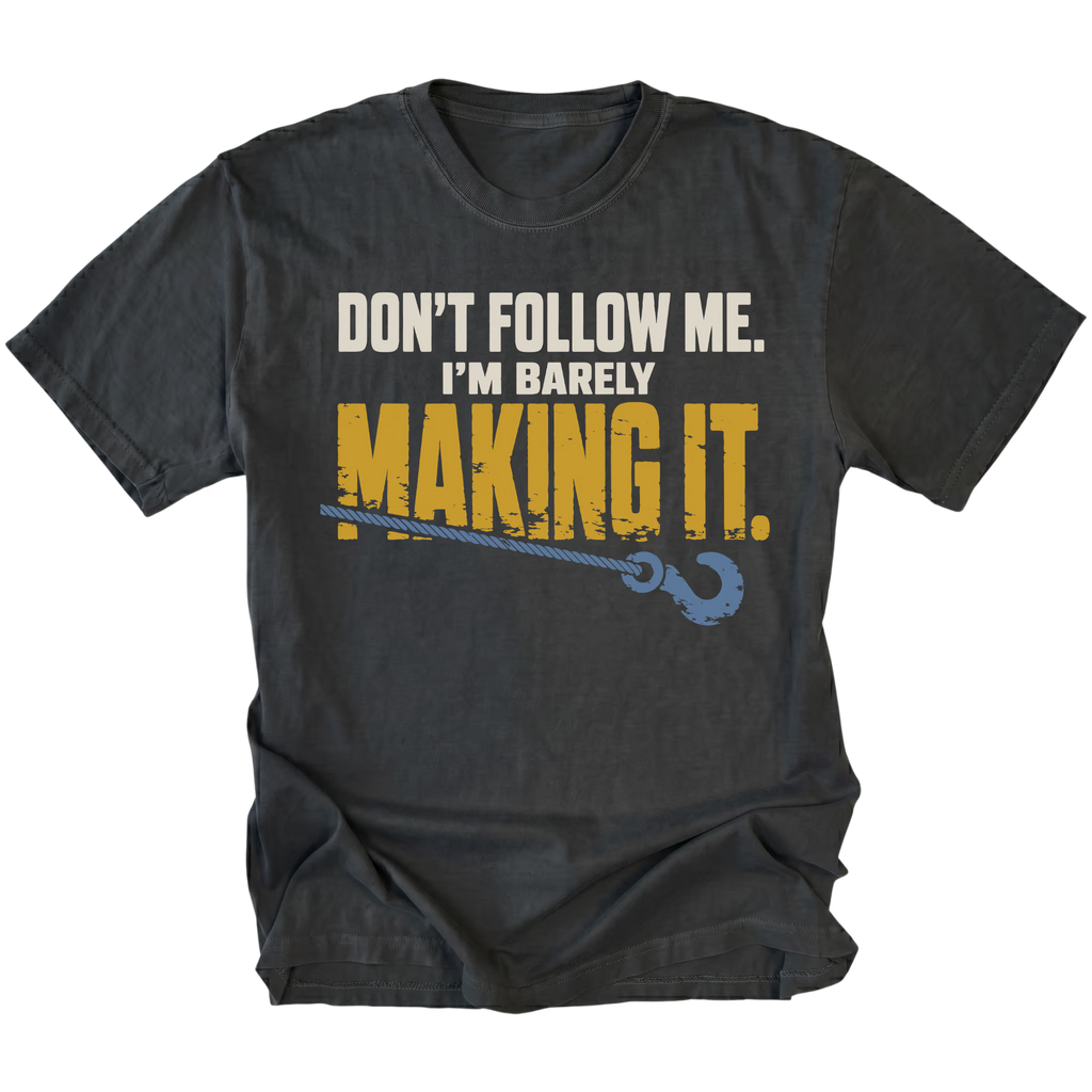 Black T-shirt featuring the Barely Making It recovery hook design on the front by Trail Snark.
