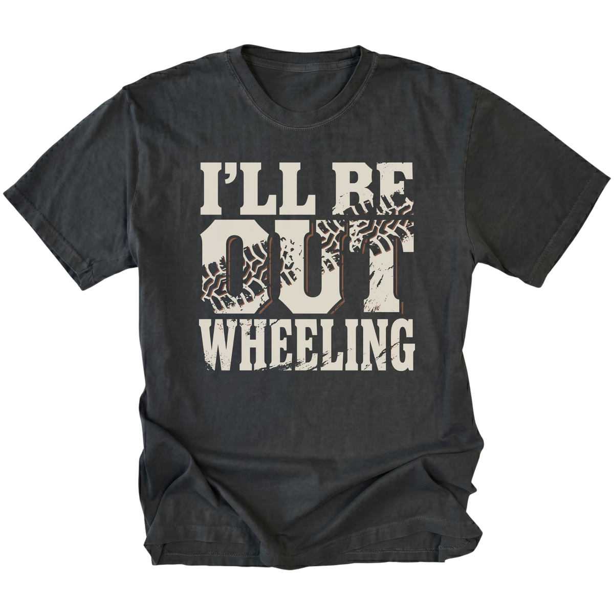 A black t-shirt with a distressed graphic on the front that reads 'I'LL BE OUT WHEELING' in cream-colored lettering, featuring tire tracks inside the letters 'O' and 'U'.