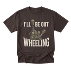 A dark brown short-sleeve t-shirt with a graphic print of a tank gun barrel and the text 'I'LL BE OUT WHEELING' in cream-colored lettering, displayed on a solid white background.
