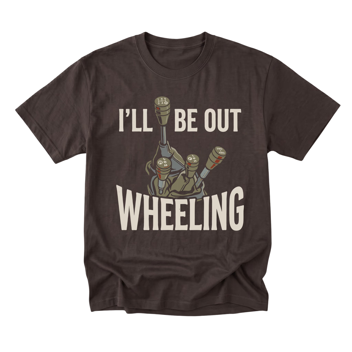 A dark brown short-sleeve t-shirt with a graphic print of a tank gun barrel and the text 'I'LL BE OUT WHEELING' in cream-colored lettering, displayed on a solid white background.