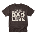 A dark brown short-sleeve t-shirt with a distressed graphic on the front that reads 'I'LL BE TAKING THE BAD LINE' in cream-colored text, displayed on a solid white background.