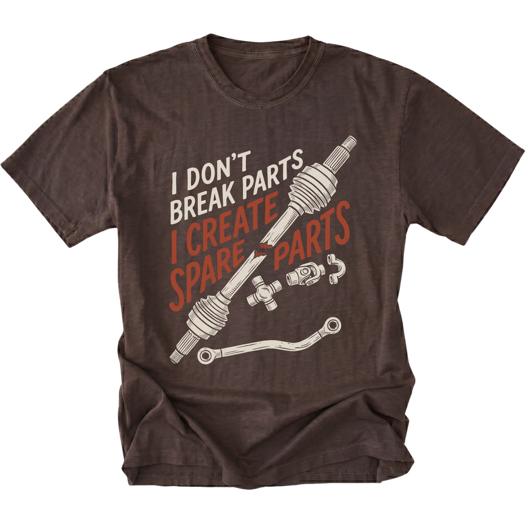 A dark brown short-sleeve t-shirt with a graphic print of a car steering knuckle and hose, accompanied by the text 'I DON'T BREAK PARTS I CREATE SPARE PARTS' in white and orange lettering.