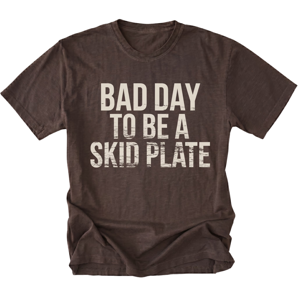 Espresso t-shirt featuring bold bad day to be a skid plate text graphic shown from the front by Trail Snark.
