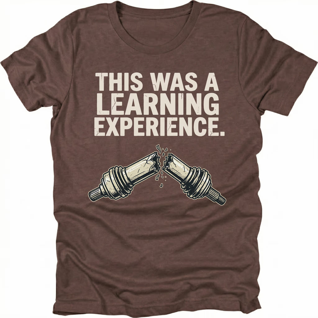 Espresso t-shirt with text reading “This Was a Learning Experience” above an illustration of a broken axle or CV joint, shown on the front.