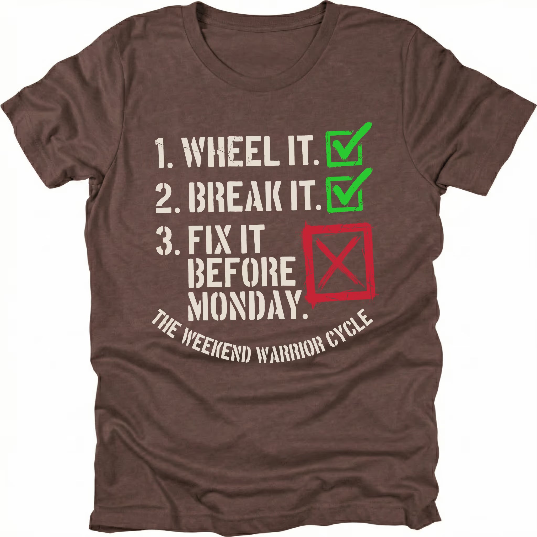 Espresso t-shirt with checklist text reading “1. Wheel It. 2. Break It. 3. Fix It Before Monday” with checkmarks and a red X, labeled “The Weekend Warrior Cycle.”