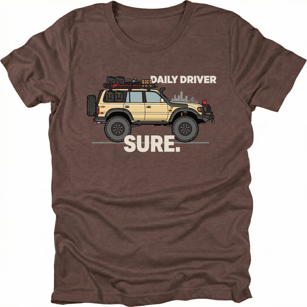 Espresso t-shirt featuring a built off-road vehicle with daily driver sure text graphic shown from the front by Trail Snark.
