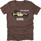 Espresso t-shirt featuring a built off-road vehicle with daily driver sure text graphic shown from the front by Trail Snark.