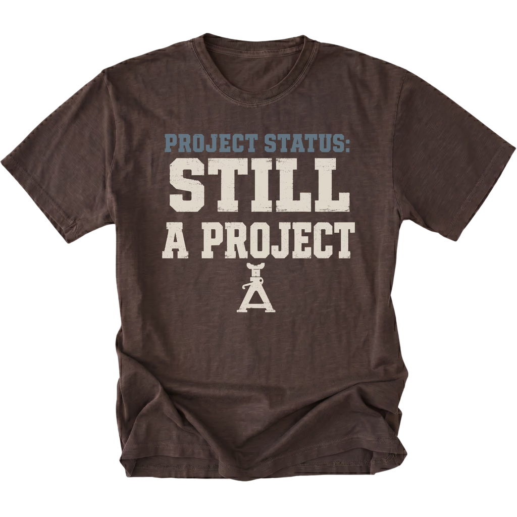 An Espresso Brown T-Shirt featuring the Still A Project design on the front by Trail Snark.