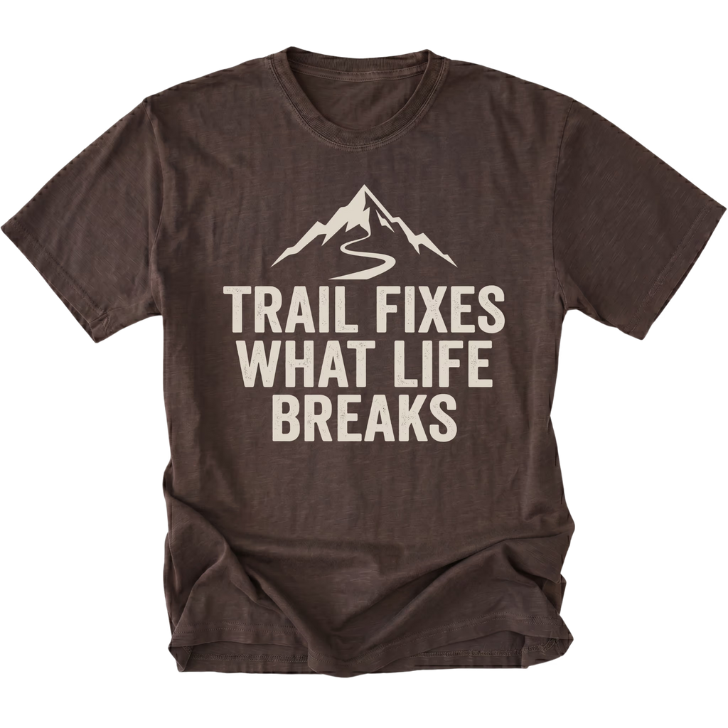 Espresso t-shirt with the phrase “Trail Fixes What Life Breaks” beneath a mountain and winding trail graphic printed on the front.