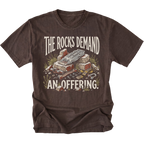 A dark brown short-sleeve t-shirt with a graphic print on the front. The graphic features the text 'THE ROCKS DEMAND AN OFFERING.
