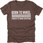 Espresso t-shirt featuring born to wheel forced to work overtime text with tire track graphic shown from the front by Trail Snark.