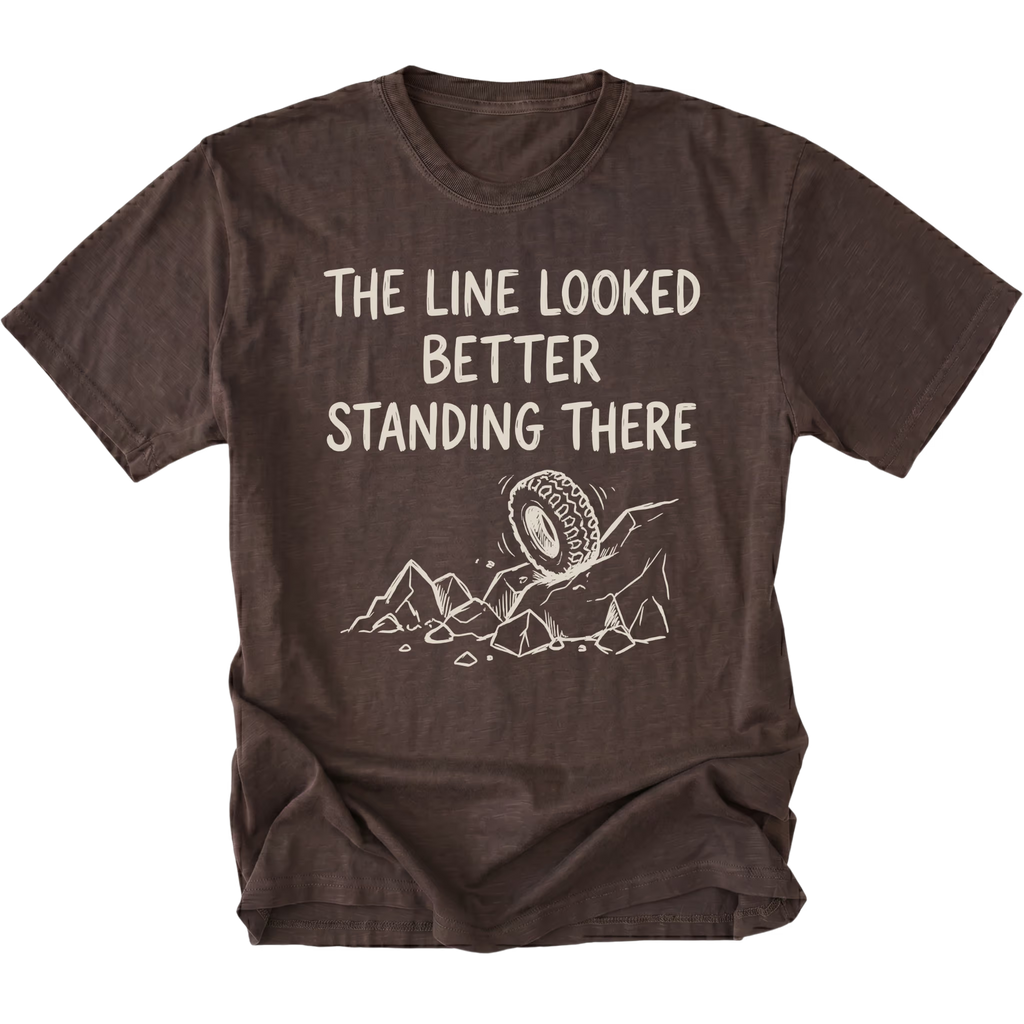 Espresso T-Shirt with hand-drawn tire and rocks graphic and text reading “The Line Looked Better Standing There” shown on front view by Trail Snark.