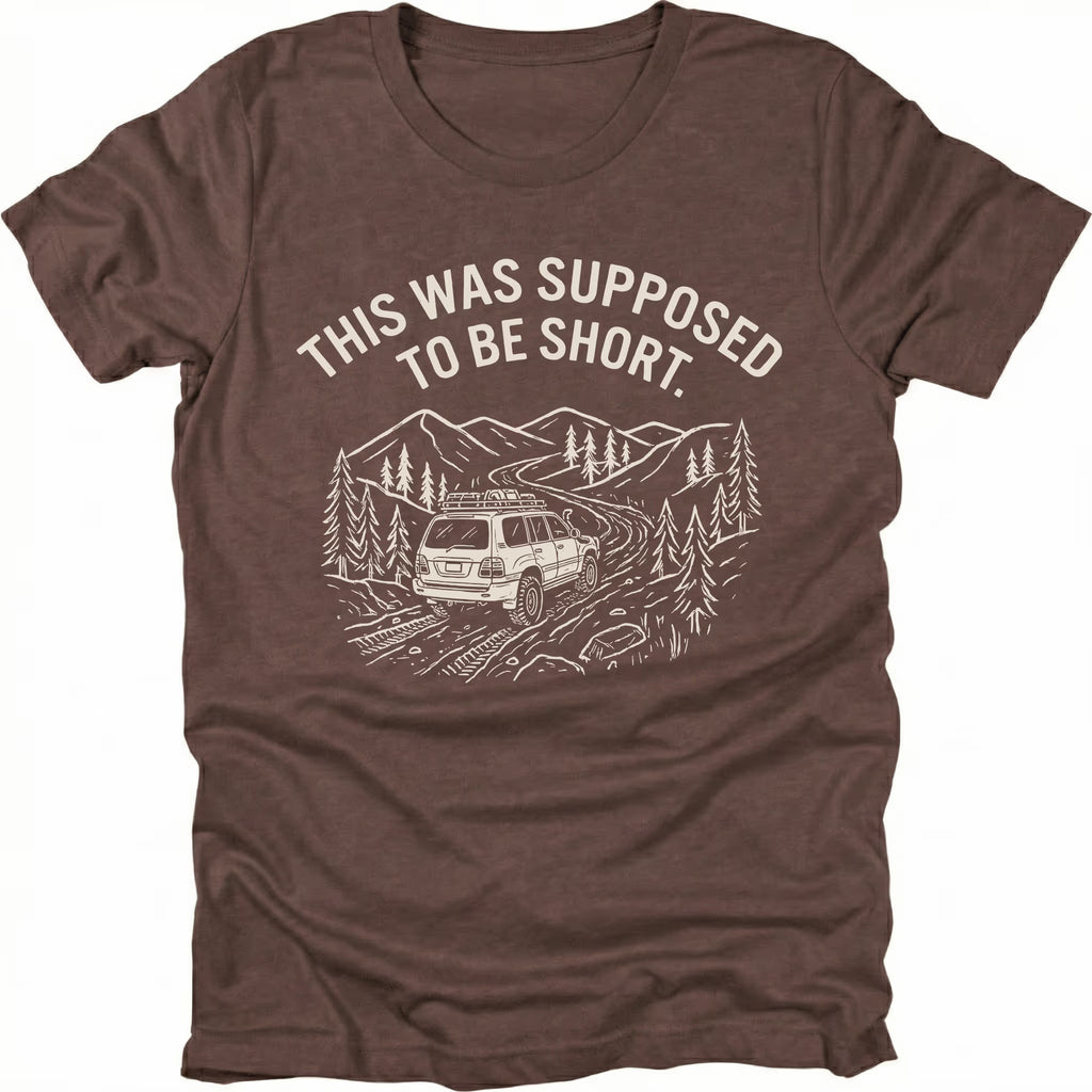 Espresso t-shirt with text reading “This Was Supposed to Be Short” above an illustration of an SUV driving a winding forest trail through mountains.