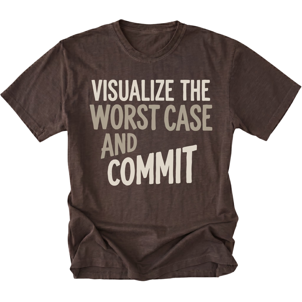 A dark brown short-sleeve t-shirt with a distressed texture, featuring the text 'VISUALIZE THE WORST CASE AND COMMIT' printed on the front in a light beige font, shown against a plain white background.